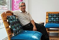 Ein Mann sitzt im Welcome Point auf dem Sofa.