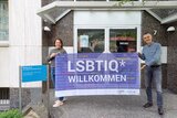 Mitarbeitende der Evangelischen Beratungsstelle Oberkassel mit einem LSBTIQ*-Willkommen-Banner